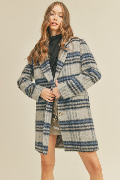 Stay effortlessly sophisticated in our Brushed Plaid Long Coat, a timeless wardrobe essential with a modern twist. Crafted in a classic grey and navy plaid, this coat combines elegance and practicality for chilly days.

Features:

Brushed Plaid Design: Soft texture with a refined grey and navy pattern
Notched Lapel: Adds a polished, tailored touch
Button Closure: Secure and sleek for a streamlined silhouette
Long Sleeves: Full coverage for warmth and style
Pockets: Functional and perfect for essentials
Line