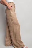 Indulge in the ultimate comfort and style with our Coco Linen Wide Leg Pants. These high waisted pants are designed with a smocked waist and waist tie for a flattering fit, while the side pockets add convenience. Perfect for both casual and dressy occasions, these pants will elevate your wardrobe.  Product Details:  65% Rayon, 35% Linen Model is 5'8