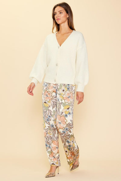 Wrap up in the world's coziest cardigan! Just Jewels Button Cardigan will keep you warm and stylish with its cream v-neck and beautiful jewel buttons. Add a touch of glamour and elegance while cozying up in the ultimate cardigan! Pairs perfectly with our Fall Floral Pants!