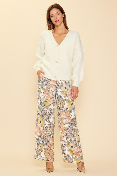 Wrap up in the world's coziest cardigan! Just Jewels Button Cardigan will keep you warm and stylish with its cream v-neck and beautiful jewel buttons. Add a touch of glamour and elegance while cozying up in the ultimate cardigan! Pairs perfectly with our Fall Floral Pants!