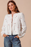 Fall in love with the romantic charm of this ivory blouse, adorned with delicate red heart embroidery that adds a playful pop of color. Featuring an elegant front-tie detail and feminine puff sleeves, this top strikes the perfect balance between sweet and sophisticated. The lightweight fabric drapes beautifully, making it ideal for date nights, casual outings, or festive occasions. Pair it with your favorite jeans, skirts, or tailored trousers to create a look that’s effortlessly chic and full of love!