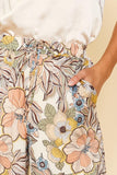 Step out in style wearing our Fall Floral Pant. Crafted from a luxurious cream satin fabric, adorned with a delicate floral print, and finished with a tie waist for a timeless tailored look, these wide leg pants will add a subtle yet chic touch to any outfit.  Product Details:  100% Polyester