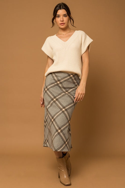 The Penny Plaid Skirt is a truly timeless piece – crafted with a unique grey plaid design and bias cut, it offers an elegant, yet versatile appearance that adds sophisticated depth to any wardrobe. Its midi length complements a variety of styles for effortless look.