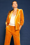 This Very Velvet Blazer's luxurious mustard plush velvet is sure to exude an air of elegance. Featuring an open front, notched lapels, and ruched three-quarter sleeves, this timeless piece is the perfect way to add a touch of sophistication to any outfit.  Product Details:  90% polyester and 10% spandex Looser fit, consider sizing down