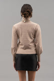 A timeless turtleneck top in a classic taupe hue provides you with effortless style. Perfect for dressing up or for a causal pairing with jeans. Get wrapped up in this cozy top today!  Product Details:  50% Rayon, 28% Polyester, 22% Nylon, Long sleeve Knit