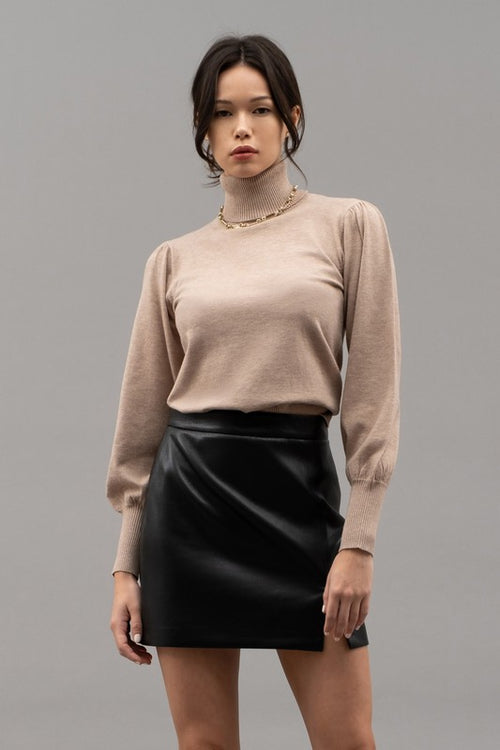 A timeless turtleneck top in a classic taupe hue provides you with effortless style. Perfect for dressing up or for a causal pairing with jeans. Get wrapped up in this cozy top today!  Product Details:  50% Rayon, 28% Polyester, 22% Nylon, Long sleeve Knit