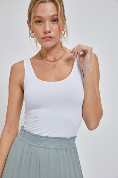 This great basic jersey tank is soft and stretchy. With a scoop neckline and made of a spandex mix material to provide a comfortable fit. It comes it three great colors – black, white and mango!  Product Details:  95% Rayon, 5% Spandex Double lined for extra security