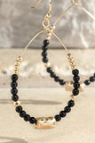 Dazzling teardrop earrings with a natural black stones and hammered metal gold beads.  Product Details:  Dangle drop fish hook design Approximately 2