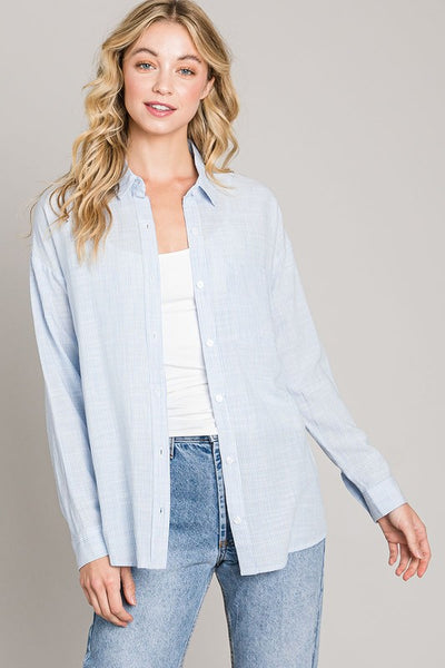 This easy breezy relaxed fit button down shirt screams ocean view! The blue thin strips and light weight make it the perfect transition piece.   Tie it, button it up or leave it unbuttoned with a tank underneath, so many options of how to style this classic.   Product Details:  70% Rayon 30% Cotton Oversized fit Hits at the hips Light weight Button down top Think strips