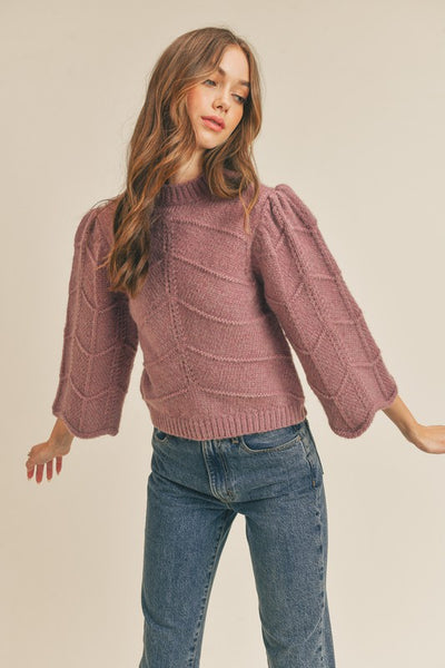 How cute is this mauve chevron sweater. With 3/4 bell sleeves and scalloped cuffs, you'll definitely fall in love with it.   Product Details:  Fabric - 70% Acrylic, 20% Polyester, 10% Spandex Shorter cropped style  3/4 bell sleeves Scalloped cuffs Ribbed crew neckline and hem Chevron knit design Model is 5' 9" 33-25.5-36 and wears a small