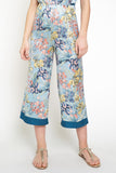 The cropped wide leg pant is alive and well and ready to become apart of your must-have summer style. Satin smooth and stunning blue floral print is a show stopper. Style with matching floral cami or pair with a white linen button down for a different vibe!  Product Details:  100% Polyester  Cropped, midi length Elastic waist Contrast trim hem Fits true to size Model wears size small & is 5'9
