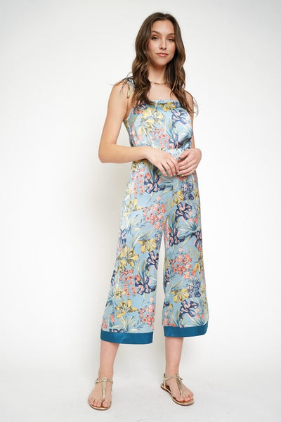 The cropped wide leg pant is alive and well and ready to become apart of your must-have summer style. Satin smooth and stunning blue floral print is a show stopper. Style with matching floral cami or pair with a white linen button down for a different vibe!  Product Details:  100% Polyester  Cropped, midi length Elastic waist Contrast trim hem Fits true to size Model wears size small & is 5'9"