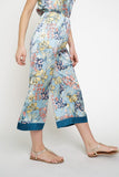The cropped wide leg pant is alive and well and ready to become apart of your must-have summer style. Satin smooth and stunning blue floral print is a show stopper. Style with matching floral cami or pair with a white linen button down for a different vibe!  Product Details:  100% Polyester  Cropped, midi length Elastic waist Contrast trim hem Fits true to size Model wears size small & is 5'9