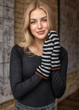 Keep your hands warm this winter with these grey and black striped fleeced lined mittens. The perfect color combo to pair perfectly with all your winter coats.   Product Details:  Fleece lined