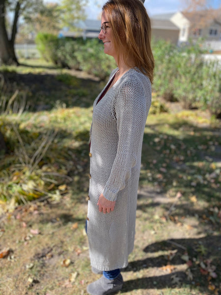This will be a fan favorite -  our new heather grey knitted mid length cardigan. Featuring a button front closure with tortoise shell buttons.   Product Details:  Thick knit Button closure No pockets