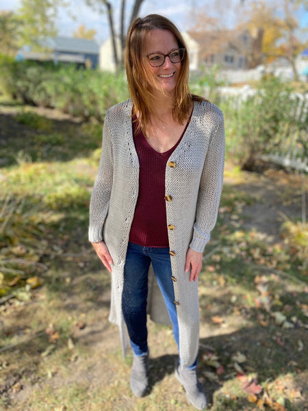 This will be a fan favorite -  our new heather grey knitted mid length cardigan. Featuring a button front closure with tortoise shell buttons.   Product Details:  Thick knit Button closure No pockets