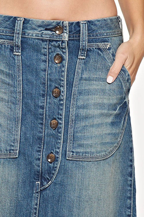 Button down front jean skirt that is the perfect length. Love the front pockets and cute button detail down the front of the skirt. Raw hem and button detail on the back. This jean skirt is amazing quality and that extra special piece that will become your go to stable.