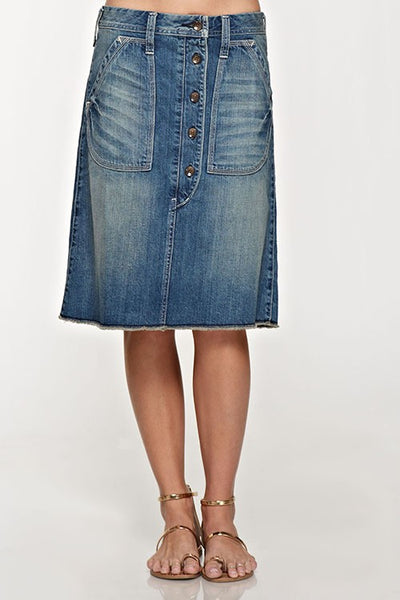 Button down front jean skirt that is the perfect length. Love the front pockets and cute button detail down the front of the skirt. Raw hem and button detail on the back. This jean skirt is amazing quality and that extra special piece that will become your go to stable.