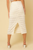The next sunny day calls for this ivory lace skirt. The intricate lace detail elevates this look and is perfect for a summer event. Lined half way and completed with a sheer lace to hem. Pair with matching top or add a pop of color, so many styling options.  Product Details:  95% Polyester, 5% Spandex Lining 100% Polyester Half lined Zip closure Midi length Back slit
