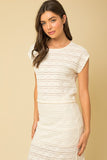 Add a little fancy to your wardrobe with this short sleeve Ivory lace top. Featuring a cropped length, unlined with keyhole button closure. Pair with matching skirt or dress down with a pair of jeans.   Product Details:  95% Polyester, 5% Spandex Keyhole with button closure Loser fit Short sleeve Unlined Matching set with Lilian Lace Midi Skirt 