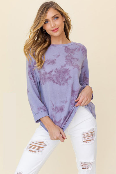 This lavender tie dye top is as lovely as a lilac in Spring. The on trend lavender color will be a perfect fit to style with summer whites. It's a must have!  Product Details  3/4 sleeve Round neck Model is wearing a small