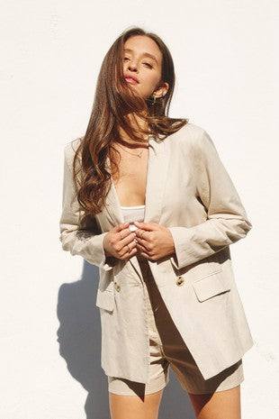 This khaki cotton and linen blended blazer is so easy to wear. Featuring an oversized fit, double breasted one button closure, flap pockets, and lightly padded shoulders. Pair with a dress to the matching shorts and everything in between. It is truly a fabulous find and will be in constant rotation in my closet!   Product Details:  55% Cotton, 45% Linen Lining 100% Cotton Light weight Oversized, so considering sizing down