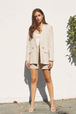 This khaki cotton and linen blended blazer is so easy to wear. Featuring an oversized fit, double breasted one button closure, flap pockets, and lightly padded shoulders. Pair with a dress to the matching shorts and everything in between. It is truly a fabulous find and will be in constant rotation in my closet!   Product Details:  55% Cotton, 45% Linen Lining 100% Cotton Light weight Oversized, so considering sizing down