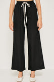 Flowy linen tie-front wide leg pants perfect for warmer weather. For an effortless look pair with a simple tank or 3/4 sleeve tie top to transition into Fall.   Breathable Linen Blend Contrast Drawstring Waist Wide Leg Silhouette Side Pockets Unlined Measurements:  Size	Waist	Inseam Small	12.5
