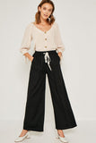 Flowy linen tie-front wide leg pants perfect for warmer weather. For an effortless look pair with a simple tank or 3/4 sleeve tie top to transition into Fall.   Breathable Linen Blend Contrast Drawstring Waist Wide Leg Silhouette Side Pockets Unlined Measurements:  Size	Waist	Inseam Small	12.5