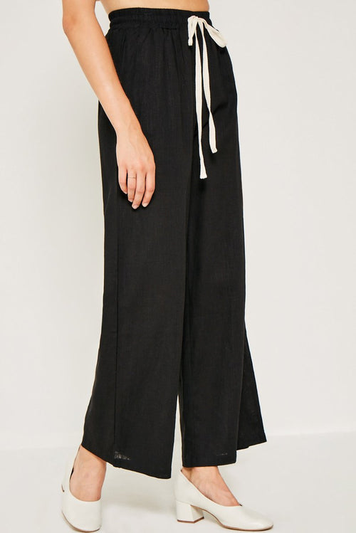 Flowy linen tie-front wide leg pants perfect for warmer weather. For an effortless look pair with a simple tank or 3/4 sleeve tie top to transition into Fall.   Breathable Linen Blend Contrast Drawstring Waist Wide Leg Silhouette Side Pockets Unlined Measurements:  Size	Waist	Inseam Small	12.5"	30" Medium	13.5"	30.5" Large	14.5"	31" These measurements reflect the garment laying flat.   Material & Care:  70% Viscose 30% Linen Hand Wash Cold Hang Dry