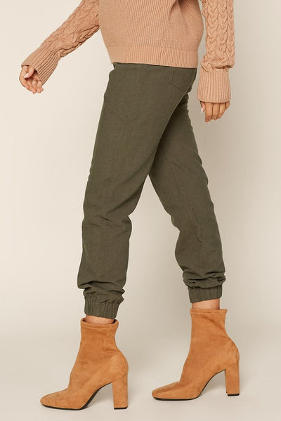 These easy pull on joggers scream stylish comfort! The classic olive color can be dressed up or down. A must have pant for Fall!  Product Details:  65% Cotton, 35% Rayon Side pockets
