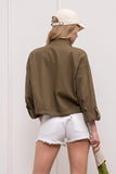 This is a must have jacket! Functional and fashionable describes this olive utility jacket perfectly. Lightweight with large front pockets and cropped style, it's the perfect Fall transitional jacket. It can be paired just about with everything!  Product Details:  100% Cotton Mock turtle neckline Light weight Long sleeves Front zip up Extra large front pockets Button cuffed sleeves
