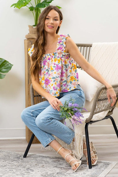 Upgrade your closet with this effortless, feminine floral top. Featuring ruffled smocked shoulder straps and a-line silhouette. The pink floral print is girly and fun.  A perfect top for a day in the sun!  Product Details:  100% Polyester Elastic ruffle strap Square neckline Not lined