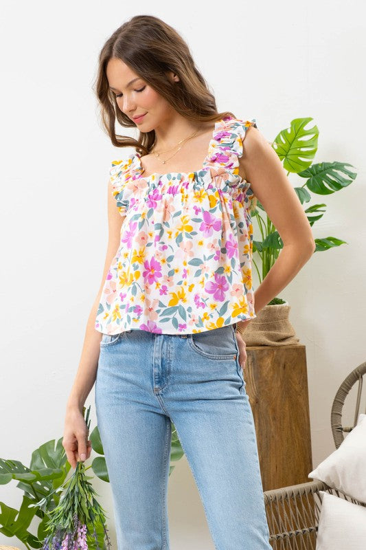 Upgrade your closet with this effortless, feminine floral top. Featuring ruffled smocked shoulder straps and a-line silhouette. The pink floral print is girly and fun.  A perfect top for a day in the sun!  Product Details:  100% Polyester Elastic ruffle strap Square neckline Not lined