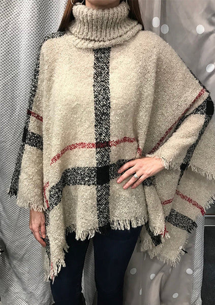 This classic plaid poncho is so comfortable and warm you won't want to take it off!! A unique turtleneck style with fun fringe detail is perfection! One size fits most. 