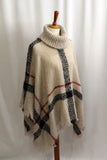 This classic plaid poncho is so comfortable and warm you won't want to take it off!! A unique turtleneck style with fun fringe detail is perfection! One size fits most. 