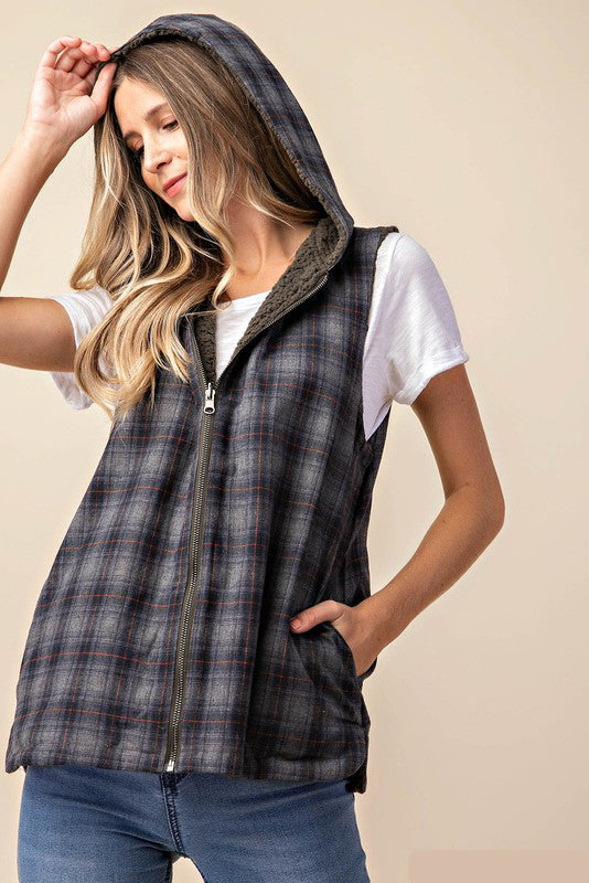 Two in one vest - plaid or sherpa - you decide! This reversible zip up hooded vest is perfect piece for colder temperatures. With a charcoal navy plaid on one side and super soft olive sherpa material on the reverse side, think of all the different outfit combos!