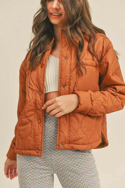 This roasted pecan quilted puffer jacket screams Fall! A perfect transitional piece featuring a boxy fit along with front patch pockets and snap front closure. An absolute essential this season!   Product Features:  100% Nylon Lined Front patch pockets Snap button closure Long sleeves with snap button cuffs Shirttail hem Model is 5' 9" 32-24.5-34.5 and wearing a small