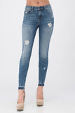 Sneak Peek distressed mid rise skinny jean with a fun released hem. Just the right amount of distress and stretch.