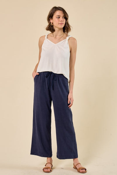 Take a break from jeans with these navy linen look pants. With a flattering straight leg style and lightweight material, they are the perfect warm weather pant.  Product Details:  60% Rayon, 40% Linen, Lining 100% Cotton Length 38 1/2", Waist 13 1/2", Inseam 26" Drawstring waist Side and back pockets Top portion is lined Hand wash