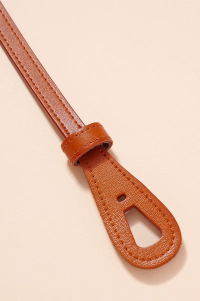 This go to camel tie belt can be accessorized with so many outfits. The thin style design is super flattering. Product Details: Approximately 45" in length Approximately 0.55" wide 100% Genuine leather One size