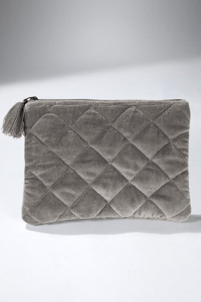 How cute is this quilted pouch! The cotton velvet material gives it a luxurious feel that you'll never want to put it down. With fun details including metallic stitching and tassel accent.   Product Details:  Shell 100% cotton and trim 100% acrylic Approximate length - 6.5" and width - 9" Zipper closure Comes in a mustard and gray color